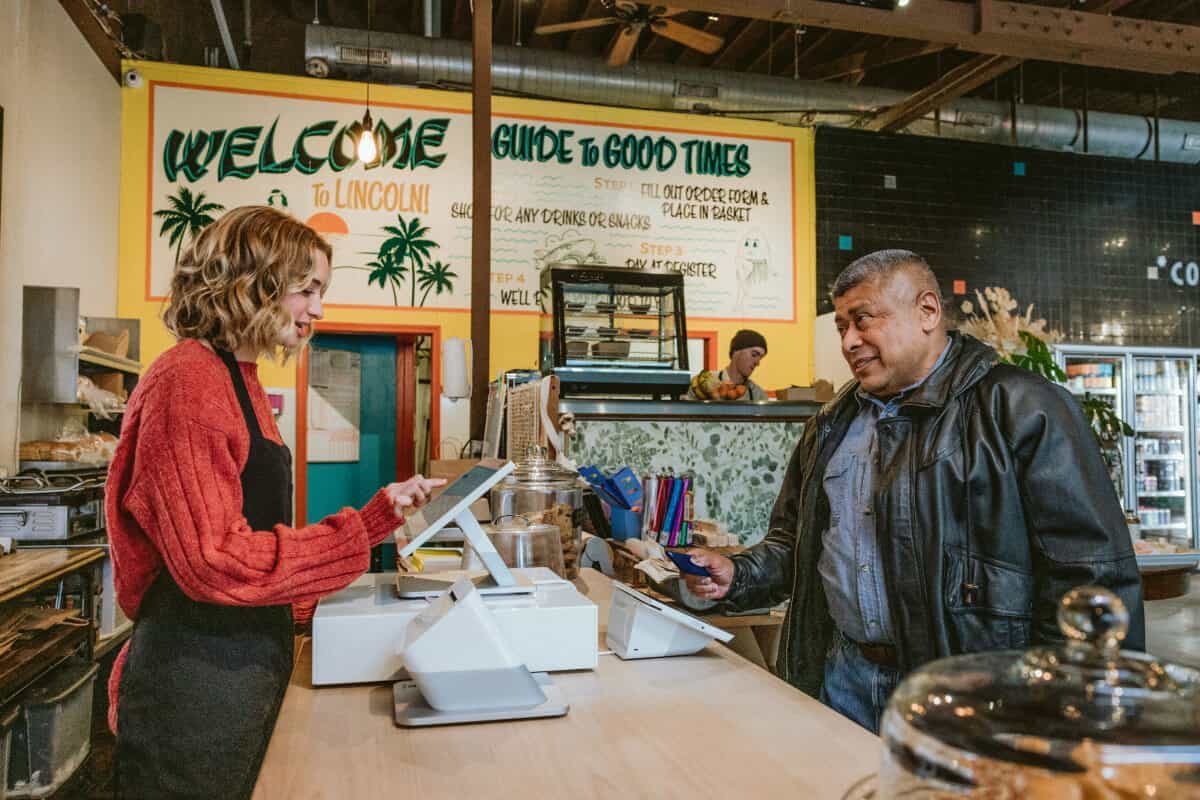 Cashier ringing up a customer on a Clover Station Duo at a quick-service counter